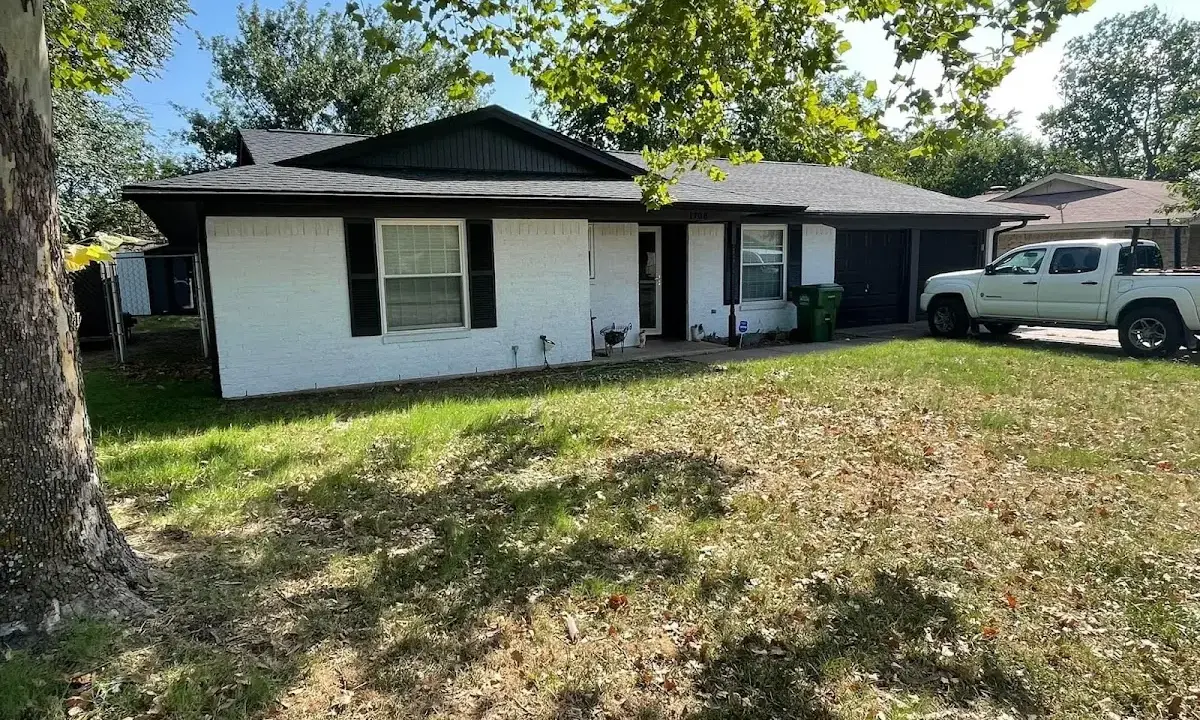 Professional roofing crew working on a residential roof in Weymouth Town